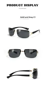Detail view of gold metal rimless sunglasses featuring rhinestone edges and grey lenses