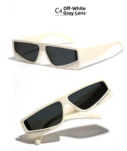 Detail of cream rectangular sunglasses with grey lenses and side rhinestone accents