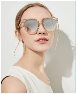 Detail of round vintage sunglasses with champagne transparent frames and gradient lenses