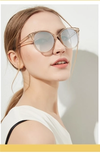 Detail of round vintage sunglasses with champagne frames and gradient mirrored lenses