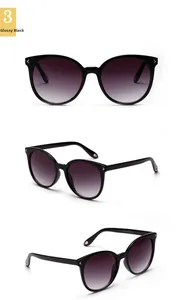 Detailed views of shiny black round sunglasses with gold accents and gradient lenses
