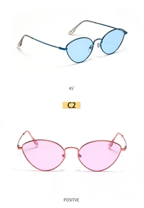 Detail of vintage cat-eye sunglasses with slim metal frames in blue and pink lenses
