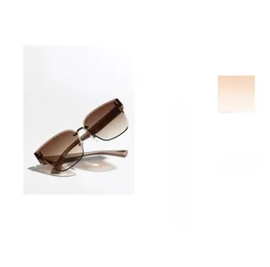 Close-up of rimless square sunglasses featuring brown gradient lenses and metal rivet details