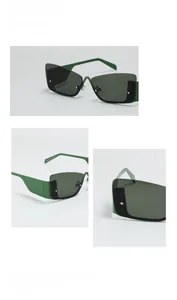 Detail view of dark green geometric cat-eye sunglasses with elegant metal rivets