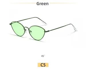 Detail view of green vintage cat-eye sunglasses with thin metal frames and ocean lenses