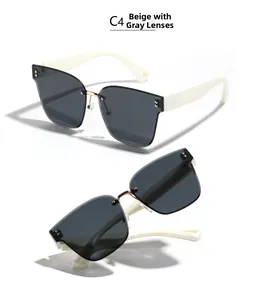 Detail view of square rimless sunglasses with beige temples and grey tinted lenses