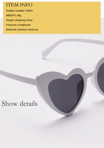 Macro detail of white heart-shaped sunglasses with PC frame and stainless steel joints