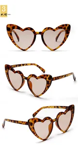 Detail view of heart-shaped sunglasses with tortoise shell frame and brown lenses