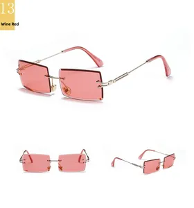Macro shot of rimless square sunglasses with wine red lenses and golden metal temples
