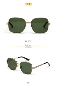 Detail view of oval metal frame sunglasses with gold frame and dark green lenses in model C3