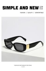 Detail of square black sunglasses with gold metal X-motif accent on the temple