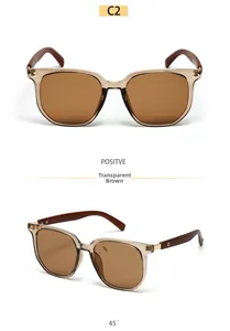 Detail of square sunglasses with transparent brown frame and dark wood grain temples