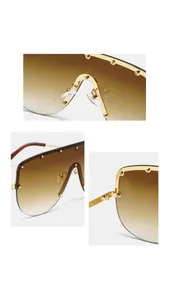 Detail view of rivet studs on brown gradient rimless lenses with gold metal hinges
