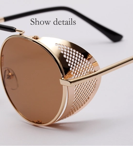 Detail view of steampunk sunglasses with golden metal mesh side shield and brown lens