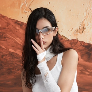 Y2K futuristic silver sunglasses with cut-out frames on model in Martian desert setting