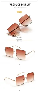 Detailed view of oversized gold metal square frame sunglasses with gradient brown lenses