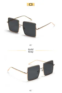 Detail of square oversized metal gold frames with dark grey lenses in 45-degree views
