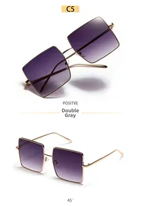 Detail view of gold metal square sunglasses with gradient gray lenses from a 45-degree angle