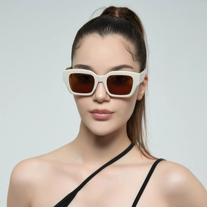 Retro rectangular oversized sunglasses with cream frame and dark lenses on model