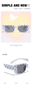 Detail of white rectangular sunglasses with purple butterfly print and dark lenses
