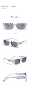 Detailed views of white square sunglasses with purple butterfly patterns and smoke lenses