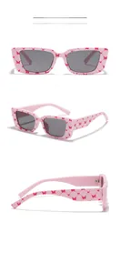 Detailed views of pink Y2K square sunglasses with red butterfly patterns and dark lenses