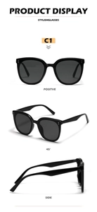 Three-angle product display of black oversized sunglasses with silver rivet details
