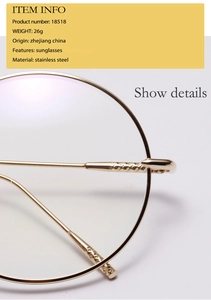 Detail view of gold stainless steel round glasses frame with engraved temple patterns