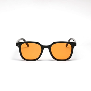Retro square black frame sunglasses with trendy transparent orange lenses and silver rivets