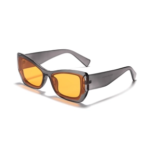 Y2K square sunglasses with translucent grey frames and orange lenses from a 45-degree angle
