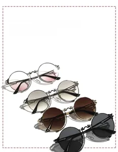 Detail view of round steampunk metal sunglasses with unique spring side wing decoration