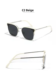 Detailansicht der beigen Cat-Eye-Sonnenbrille mit Metallbügeln und modischen Nieten