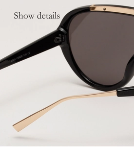 Detail of black and gold pilot sunglasses hinge with model number 2085 and CE mark
