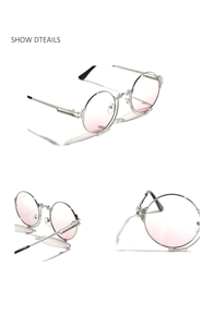 Detail view of round punk sunglasses with silver metal frame and pink gradient lenses