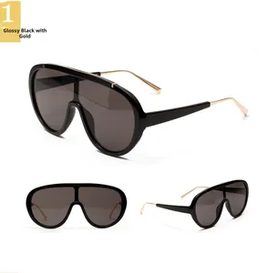 Detail view of black punk aviator sunglasses with gold metal temples and grey lenses