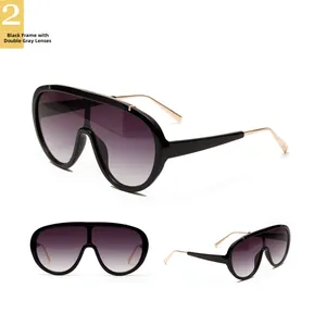 Detail of fashion aviator sunglasses with black frame, gradient grey lenses and gold metal temples