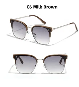 Details der milchbraunen Sonnenbrille mit Metallnieten und grauen Verlaufsgläsern