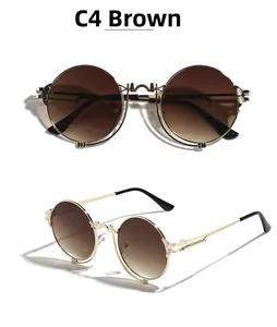 Detail of round steampunk sunglasses with gold metal frame and tea gradient lenses