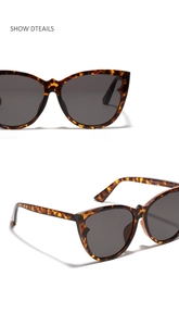 Detail view of retro cat-eye sunglasses with classic tortoise frame and gray lenses