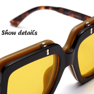 Detail of double-layer sunglasses frame with yellow lenses and metallic rivets
