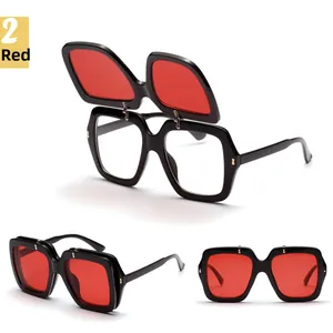 Detail view of double-layer flip-up sunglasses with red outer lenses and clear inner lenses