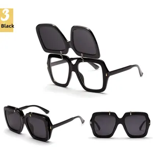 Detailed view of black flip-up sunglasses with double-layer lenses and metal hinges