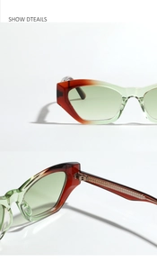 Dettaglio occhiali da sole cat-eye sfumati rosso e verde con cerniere in metallo pregiate