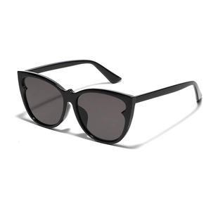 Chic black cat-eye sunglasses with scalloped wave frames and dark grey lenses for women
