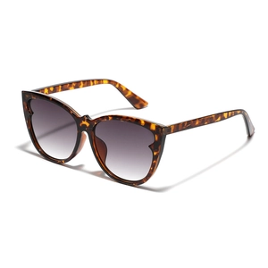 Vintage tortoiseshell cat eye sunglasses with wavy edges and gradient purple lenses