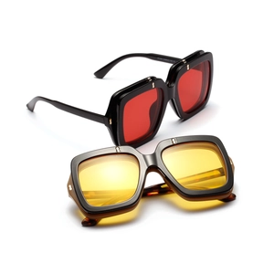 Detail showing square oversized frames with metal rivets and stylish colored lenses