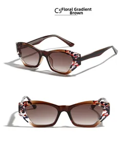 Dettaglio degli occhiali da sole TR90 cat eye con motivi floreali e lenti color tè sfumate