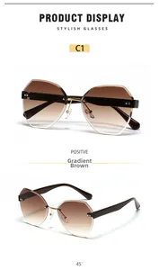 Detail view of pink rimless oversized sunglasses with gradient tea lenses and gold hinges