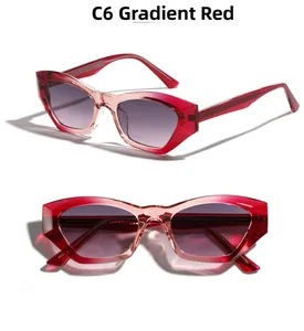 Dettaglio occhiali da sole cat-eye con lenti sfumate rosse e montatura poligonale