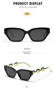 Detail of square cat eye sunglasses featuring unique golden metal chain temples in black